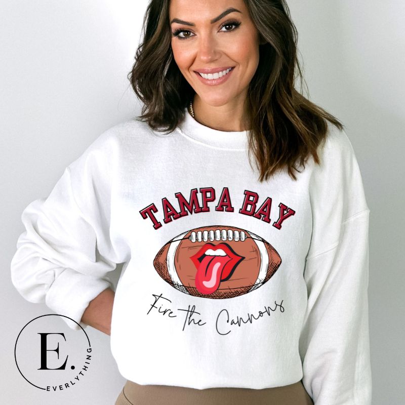Get ready to showcase your support for the Tampa Bay Buccaneers with this eye-catching sweatshirt. Featuring a football and playful lips and tongue design, it proudly displays the team's rallying cry "Fire the Cannons" and the distinctive Tampa Bay wordmark on a white sweatshirt. 