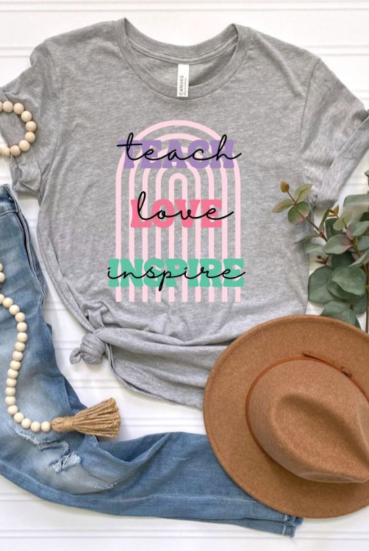 Boho rainbow design featuring the words 'teach love inspire' on a teacher graphic tee, ideal for teacher shirts and teacher gifts. Grey graphic tees.