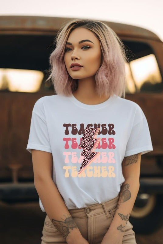 "White teacher graphic tee with pink cheetah lightning bolt and the word 'teacher' - perfect for teacher shirts and teacher gifts. Eye-catching graphic tee for educators."