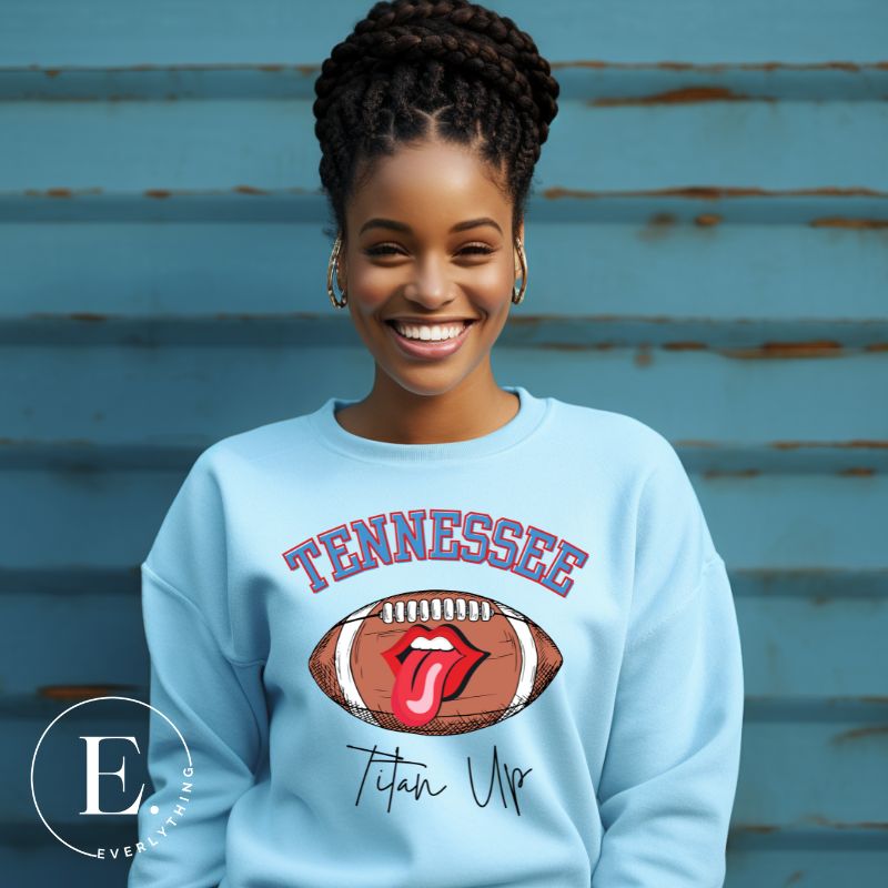 Elevate your game-day look with this Tennessee Titans sweatshirt, featuring a football and unique lips and tongue design. Complete with the team's rallying cry "Titan Up" and the iconic Tennessee wordmark, on a light blue sweatshirt. 