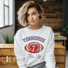 Elevate your game-day look with this Tennessee Titans sweatshirt, featuring a football and unique lips and tongue design. Complete with the team's rallying cry "Titan Up" and the iconic Tennessee wordmark, on a white sweatshirt. 