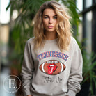 Elevate your game-day look with this Tennessee Titans sweatshirt, featuring a football and unique lips and tongue design. Complete with the team's rallying cry "Titan Up" and the iconic Tennessee wordmark, on a grey sweatshirt. 