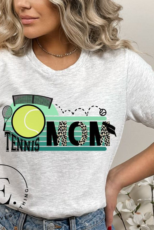 Serve up some style with our Tennis Mom shirt sublimation download. This PNG file is perfect for sublimation printing, featuring a trendy design that celebrates the pride of being a tennis mom. Show your support in fashion and make a statement on and off the court. PNG on a grey shirt. 