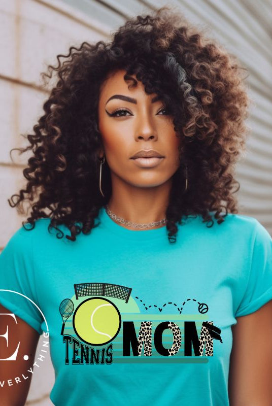 Serve up some style with our Tennis Mom shirt sublimation download. This PNG file is perfect for sublimation printing, featuring a trendy design that celebrates the pride of being a tennis mom. Show your support in fashion and make a statement on and off the court. PNG on a teal shirt. 