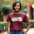 Express gratitude in style with our charming t-shirt. This design radiates autumn appreciation, featuring three pastel pumpkins and the word 'thankful' gracefully woven through the middle on a maroon shirt, 