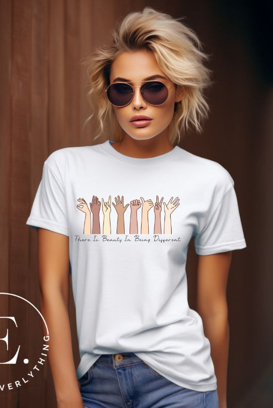 Celebrate diversity with this inspiring shirt, which features hands of different ethnicities and boldly declares "There is beauty in being different" on a white colored shirt. 