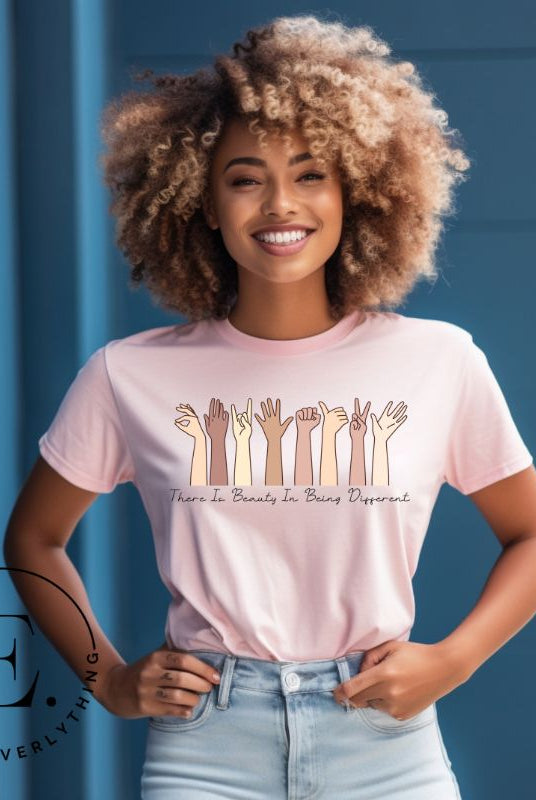 Celebrate diversity with this inspiring shirt, which features hands of different ethnicities and boldly declares "There is beauty in being different" on a pink colored shirt.