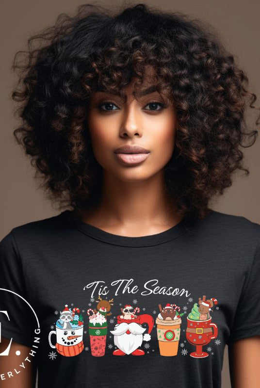 Wrap yourself in cozy holiday vibes with our Christmas coffee cup shirt. With a festive design that says "Tis The Season," this shirt captures the essence of warmth and joy. Perfect for coffee lovers who cherish the magic of the holidays on a black shirt. 