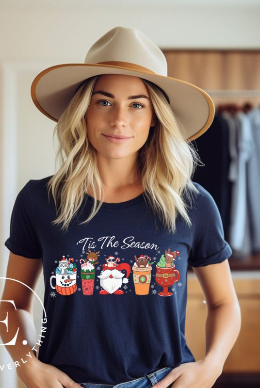 Wrap yourself in cozy holiday vibes with our Christmas coffee cup shirt. With a festive design that says "Tis The Season," this shirt captures the essence of warmth and joy. Perfect for coffee lovers who cherish the magic of the holidays on a navy shirt. 