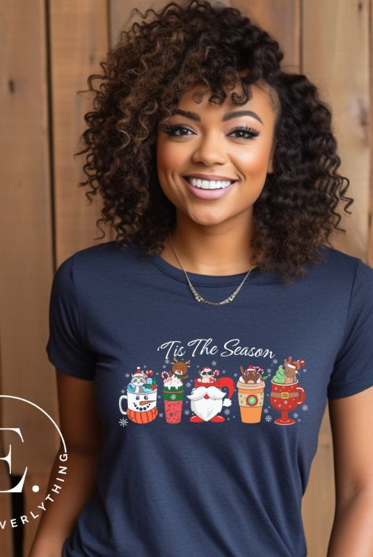 Wrap yourself in cozy holiday vibes with our Christmas coffee cup shirt. With a festive design that says "Tis The Season," this shirt captures the essence of warmth and joy. Perfect for coffee lovers who cherish the magic of the holidays on a navy shirt.