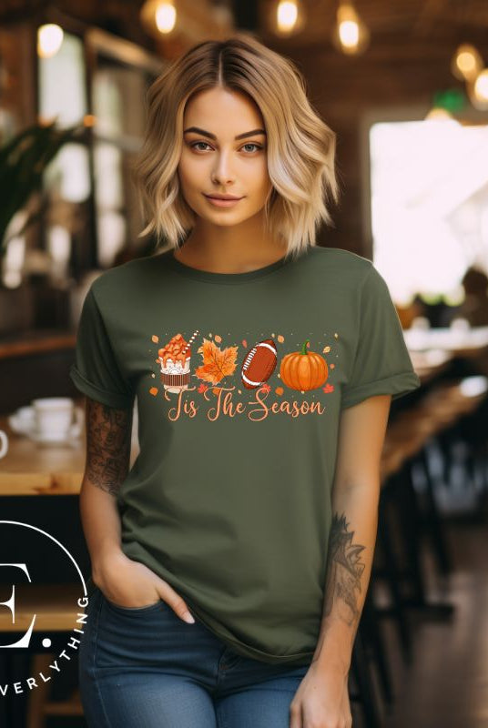 Get ready to welcome the fall season with our exclusive 'Tis The Season' football shirt! This vibrant design features fall coffee, leaves, football, and pumpkins, perfectly capturing the essence of autumn on an olive shirt. 