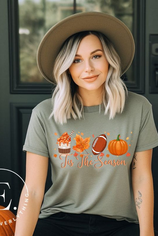 Get ready to welcome the fall season with our exclusive 'Tis The Season' football shirt! This vibrant design features fall coffee, leaves, football, and pumpkins, perfectly capturing the essence of autumn on a green shirt. 