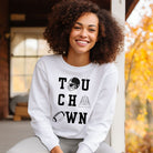 "TOUCHDOWN" letters, featuring a football helmet, field, and football graphics on a white sweatshirt. 