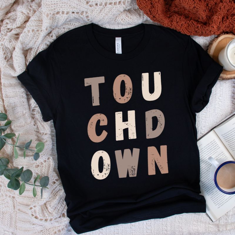 the word "TOUCHDOWN" in a stylish, distressed font with shades of brown, perfect for football fans on a black shirt