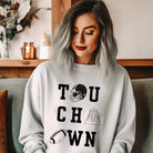 "TOUCHDOWN" letters, featuring a football helmet, field, and football graphics on a grey sweatshirt. 