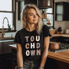 the word "TOUCHDOWN" in a stylish, distressed font with shades of brown, perfect for football fans on a black shirt