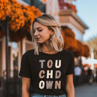 the word "TOUCHDOWN" in a stylish, distressed font with shades of brown, perfect for football fans on a black shirt