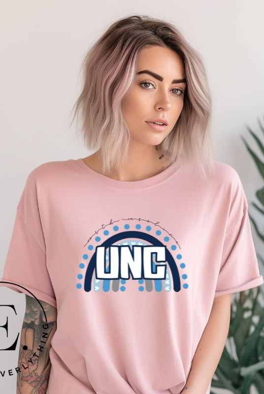 Check out this eye-catching t-shirt designed, featuring the iconic UNC letters set against a vibrant rainbow backdrop. Not only does it let you show off your school spirit, it also sends a trendy and powerful school spirit vibe on a pink shirt. 