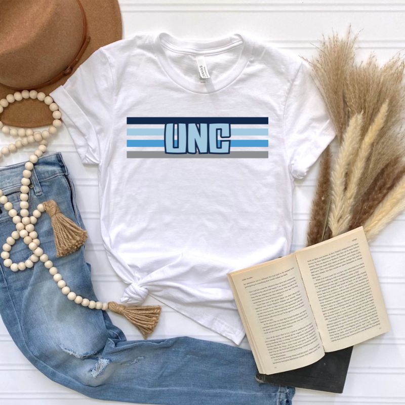 The letters "UNC" in bold blue over blue and white stripes for the University of North Carolina on a white shirt.