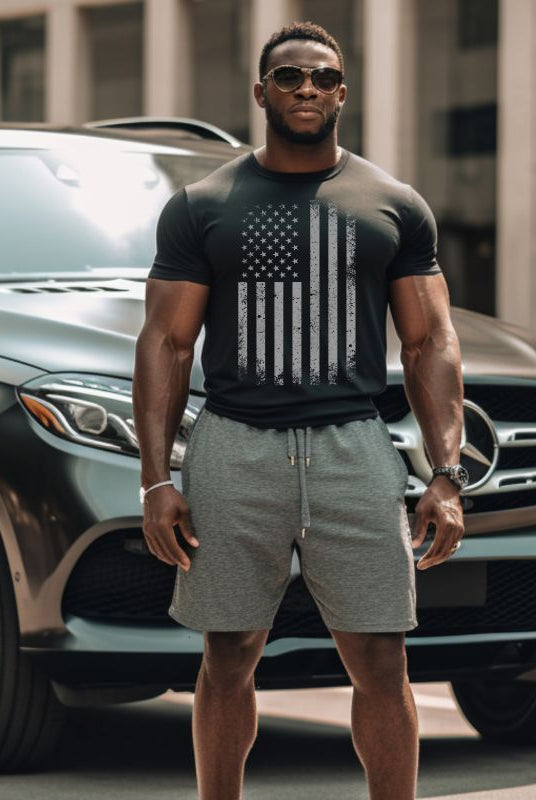 A sleek graphic tee for the USA July 4th celebration featuring a stylized grey American flag design on a black background. The tee combines a modern twist with traditional patriotic imagery, making it a timeless and fashionable choice for Independence Day celebrations.