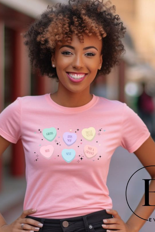 Embrace a humorous take on Valentine's Day with our shirt featuring candy hearts with unconventional messages like "Gross," "Not a Chance," "Next," "Truly Never," "Meh," "Not a Chance," and "Let's Not" on a pink shirt. 