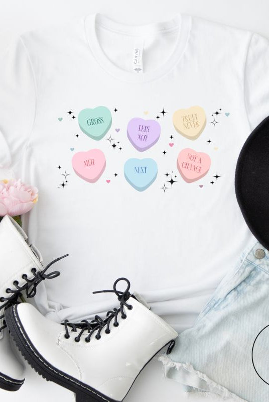 Embrace a humorous take on Valentine's Day with our shirt featuring candy hearts with unconventional messages like "Gross," "Not a Chance," "Next," "Truly Never," "Meh," "Not a Chance," and "Let's Not" on a white shirt. 