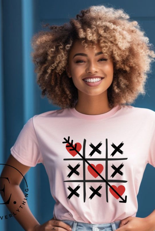 Add a playful twist to Valentine's Day with our Tic-Tac-Toe shirt featuring exes and three hearts. The winning move, an arrow through the three hearts, adds a cheeky touch to this fun and stylish on a pink shirt. 