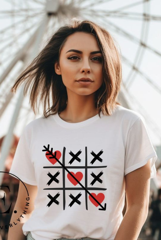 Add a playful twist to Valentine's Day with our Tic-Tac-Toe shirt featuring exes and three hearts. The winning move, an arrow through the three hearts, adds a cheeky touch to this fun and stylish white shirt. 