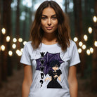 White t-shirt featuring a stylish goth girl dressed in black with a purple umbrella, along with the text "WWWD?" (What Would Wednesday Do?) in bold lettering.