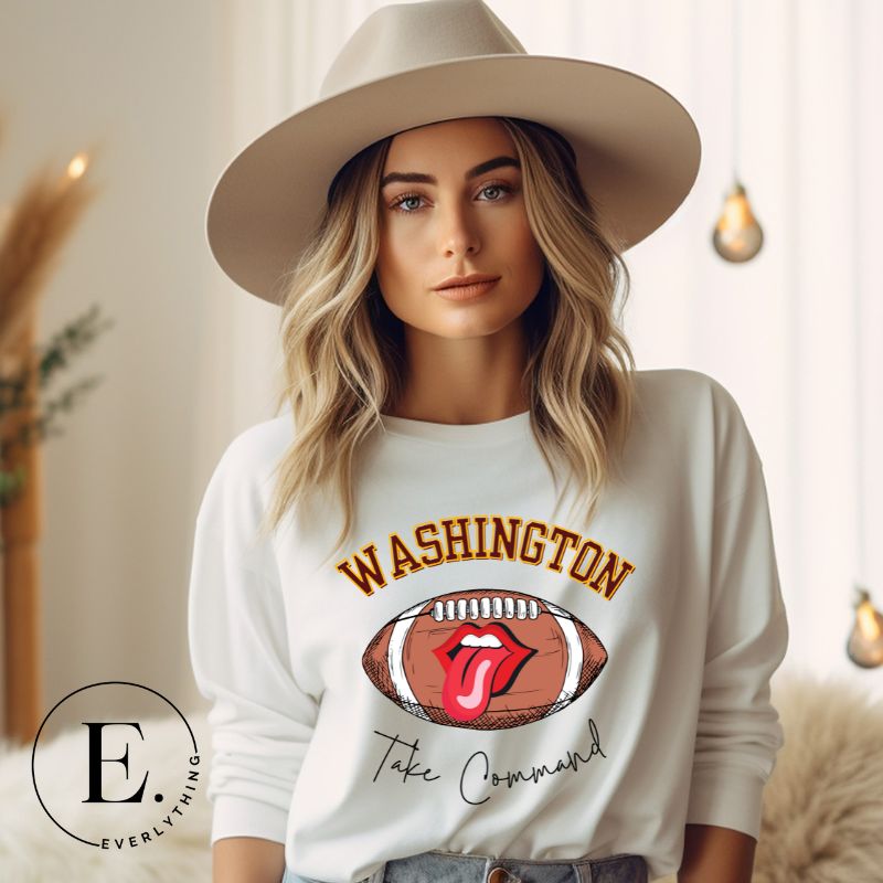 Show your support for the Washington Commanders with this stylish sweatshirt, featuring a football and fun lips and tongue design. Complete with the team's slogan "Take Command" and the distinctive Washington wordmark, on a white sweatshirt. 