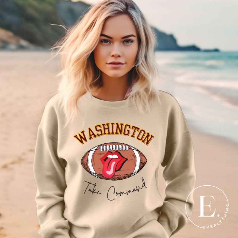 Show your support for the Washington Commanders with this stylish sweatshirt, featuring a football and fun lips and tongue design. Complete with the team's slogan "Take Command" and the distinctive Washington wordmark, on a sand colored sweatshirt. 