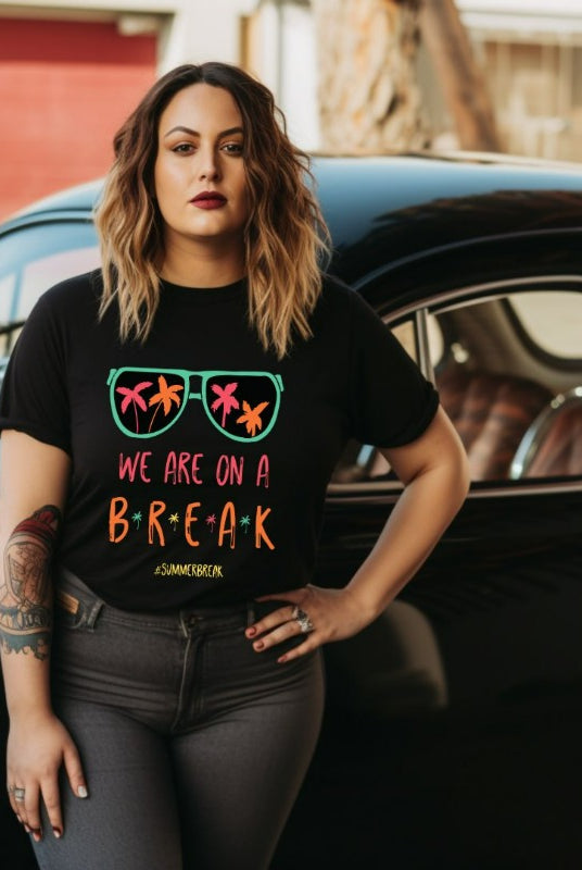 Graphic tee with the saying 'We Are On Break' and sunglasses reflecting palm trees - a fun option for teacher shirts and teacher gifts. Black graphic tees.