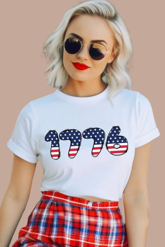 Close-up image of a USA July 4th graphic tee with the number '1776' spelled out in American flag inspired numbers on the front. This patriotic tee is perfect for celebrating Independence Day in style and showing off your love for America on a white graphic tee. 