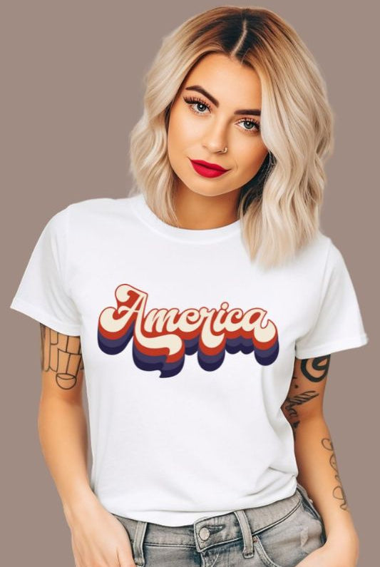 Close-up image of a USA July 4th graphic tee with the word 'America' spelled out in funky retro lettering on the front. This vintage-inspired tee is perfect for adding a fun and nostalgic touch to your Independence Day celebrations on a white graphic tee. 