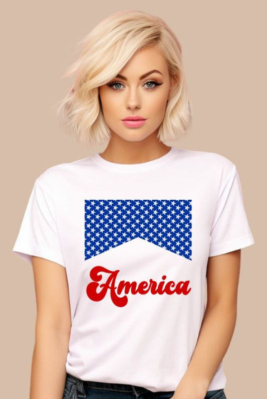 Close-up image of a USA July 4th graphic tee with the word 'America' spelled out in retro lettering on the front. The lettering is filled with iconic American flag stars, adding a patriotic touch to the design on a white graphic tee. 