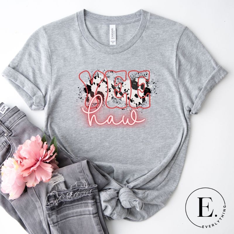 Embrace country chic with our PNG sublimation digital download! Create a stylish Western shirt featuring the word " Yeehaw" in neon pink and cowhide print. Example of PNG sublimation digital design on a grey shirt. 