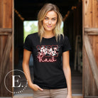 Saddle up in style with our country western shirt featuring the spirited exclamation "Yeehaw" set against a sleek cowhide print background, accented with neon pink lettering on a black shirt. 