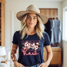 Saddle up in style with our country western shirt featuring the spirited exclamation "Yeehaw" set against a sleek cowhide print background, accented with neon pink lettering on a navy shirt. 