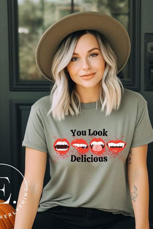 Indulge in wickedly delightful style with our vampire lips shirt. Featuring alluring lips dripping with Halloween allure, this shirt captivates with its seductive charm. The cheeky message, 'You Look Delicious,' on a green shirt. 