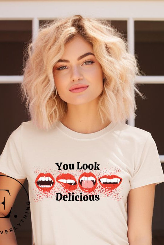 Indulge in wickedly delightful style with our vampire lips shirt. Featuring alluring lips dripping with Halloween allure, this shirt captivates with its seductive charm. The cheeky message, 'You Look Delicious,' on a soft cream shirt. 