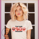 Sink your teeth into style with our 'You Look Delicious' Vampire lips Halloween shirt sublimation download. This PNG file is perfect for sublimation printing, featuring a seductively spooky design. Embrace the allure of the night and make a bold statement this Halloween. Download now and unleash your inner vampire. PNG on a soft cream shirt. 