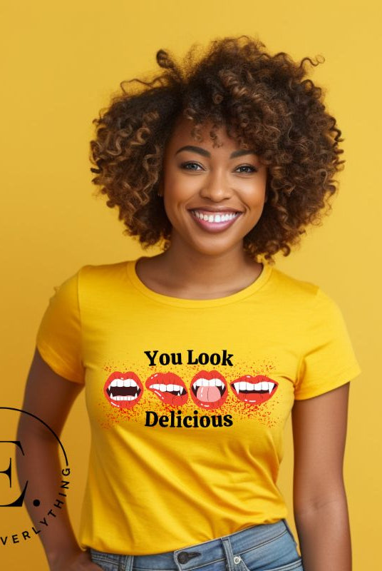 Indulge in wickedly delightful style with our vampire lips shirt. Featuring alluring lips dripping with Halloween allure, this shirt captivates with its seductive charm. The cheeky message, 'You Look Delicious,' on a yellow shirt. 