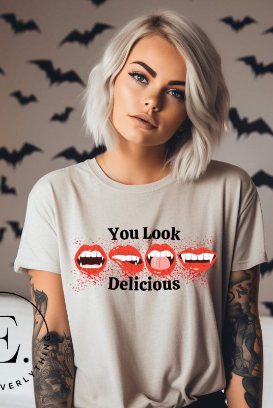 Indulge in wickedly delightful style with our vampire lips shirt. Featuring alluring lips dripping with Halloween allure, this shirt captivates with its seductive charm. The cheeky message, 'You Look Delicious,' on a tan shirt. 
