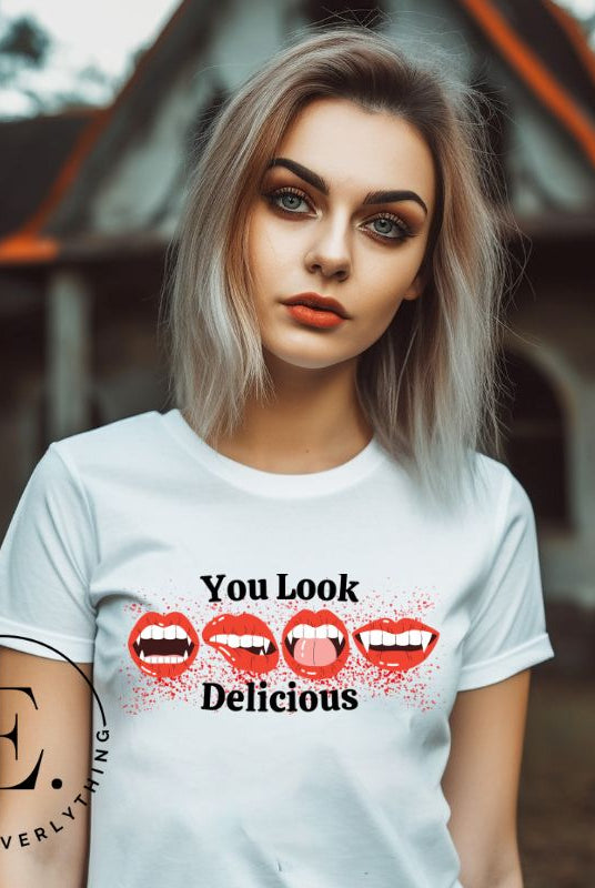 Indulge in wickedly delightful style with our vampire lips shirt. Featuring alluring lips dripping with Halloween allure, this shirt captivates with its seductive charm. The cheeky message, 'You Look Delicious,' on a white shirt. 