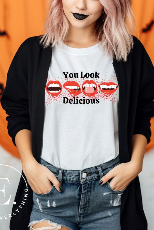 Indulge in wickedly delightful style with our vampire lips shirt. Featuring alluring lips dripping with Halloween allure, this shirt captivates with its seductive charm. The cheeky message, 'You Look Delicious,' on a white shirt. 