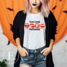 Sink your teeth into style with our 'You Look Delicious' Vampire lips Halloween shirt sublimation download. This PNG file is perfect for sublimation printing, featuring a seductively spooky design. Embrace the allure of the night and make a bold statement this Halloween. Download now and unleash your inner vampire. PNG on a white shirt. 