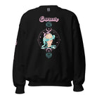 Black Gildan sweatshirt featuring a vibrant Cancer zodiac design. The front showcases an artistic representation of a woman with flowing hair adorned with a crab, surrounded by celestial elements like moons and stars, in pastel colors. The word "Cancer" is written in a stylish pink script above the design. The sleeve also has "Cancer" written vertically in matching pink script. The sweatshirt is displayed hanging on a clothing rack, accompanied by a denim jacket and a brown hat.