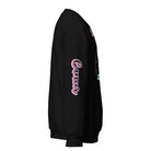 Black Gildan sweatshirt featuring a vibrant Cancer zodiac design. The front showcases an artistic representation of a woman with flowing hair adorned with a crab, surrounded by celestial elements like moons and stars, in pastel colors. The word "Cancer" is written in a stylish pink script above the design. The sleeve also has "Cancer" written vertically in matching pink script.