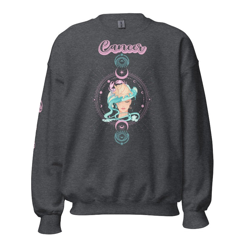 Dark Grey Gildan sweatshirt featuring a vibrant Cancer zodiac design. The front showcases an artistic representation of a woman with flowing hair adorned with a crab, surrounded by celestial elements like moons and stars, in pastel colors. The word "Cancer" is written in a stylish pink script above the design. The sleeve also has "Cancer" written vertically in matching pink script.