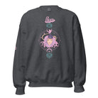 Gildan crewneck pullover sweatshirt featuring a pastel illustration of a Leo figure with flowing purple hair, surrounded by celestial elements. The word "Leo" is written in pink on the sleeve, adding a stylish touch on a dark grey sweatshirt.